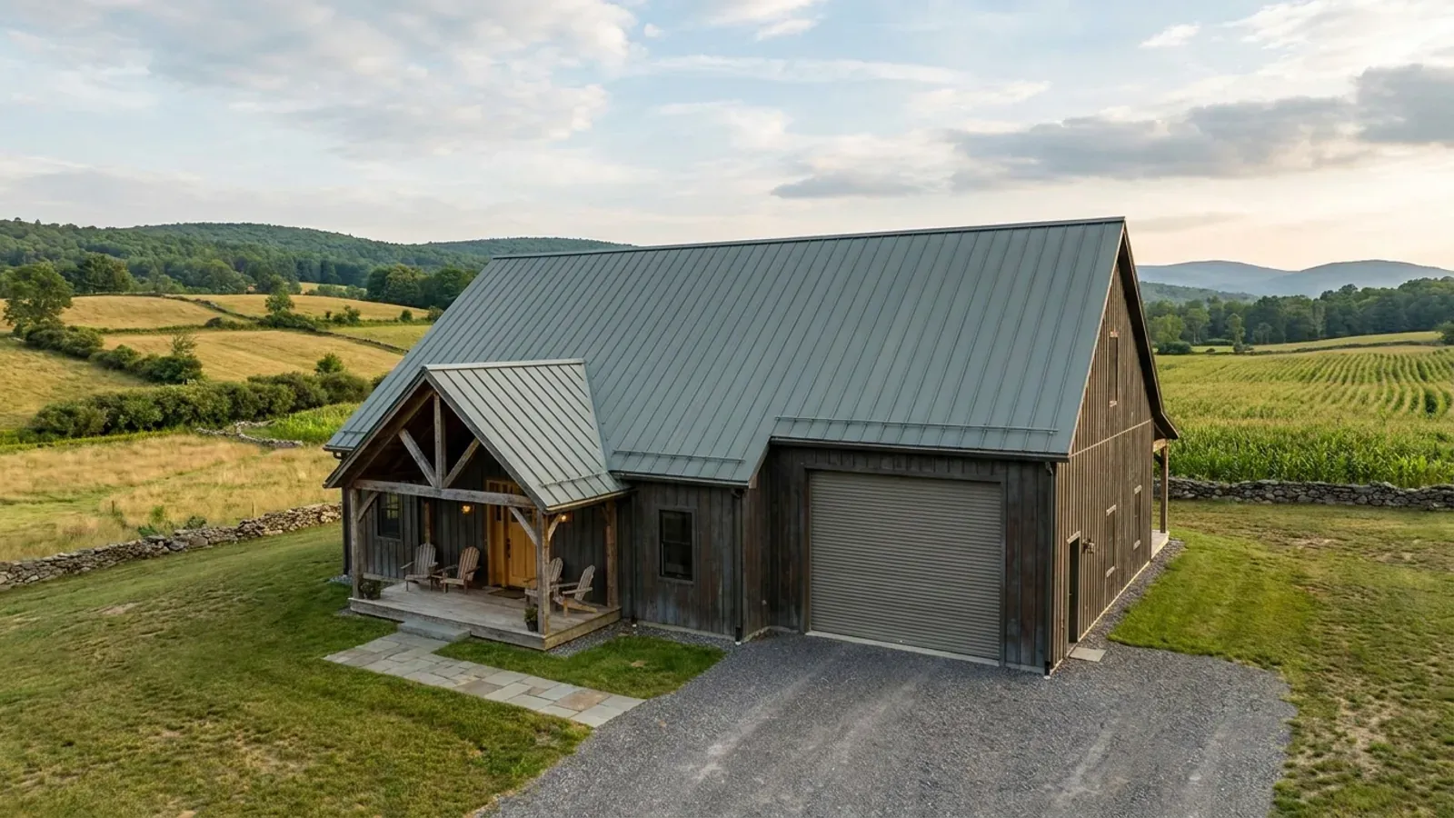A completed 40x60 barndominium showing a residential entry on one end and a wide shop door on the other under one continuous roof.